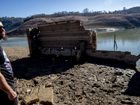 Hundreds of people are visiting the old town of Sant Roma de Sau, where normally the water of the Sau reservoir would almost completely cove...