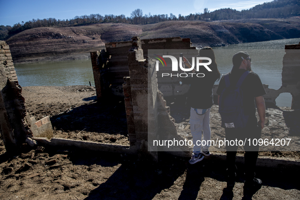 Hundreds of people are visiting the old town of Sant Roma de Sau, where normally the water of the Sau reservoir would almost completely cove...