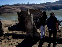 Hundreds of people are visiting the old town of Sant Roma de Sau, where normally the water of the Sau reservoir would almost completely cove...