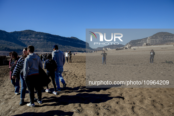 Hundreds of people are visiting the old town of Sant Roma de Sau, where normally the water of the Sau reservoir would almost completely cove...