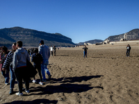 Hundreds of people are visiting the old town of Sant Roma de Sau, where normally the water of the Sau reservoir would almost completely cove...