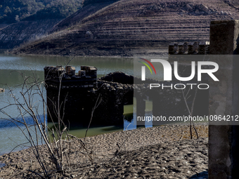 Hundreds of people are visiting the old town of Sant Roma de Sau, where normally the water of the Sau reservoir would almost completely cove...