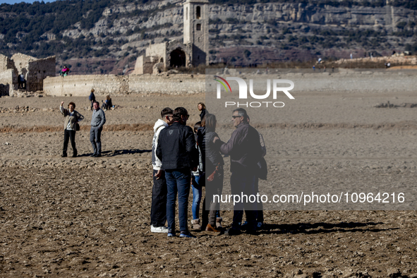 Hundreds of people are visiting the old town of Sant Roma de Sau, where normally the water of the Sau reservoir would almost completely cove...