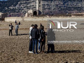 Hundreds of people are visiting the old town of Sant Roma de Sau, where normally the water of the Sau reservoir would almost completely cove...