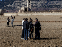 Hundreds of people are visiting the old town of Sant Roma de Sau, where normally the water of the Sau reservoir would almost completely cove...