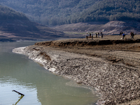 Hundreds of people are visiting the old town of Sant Roma de Sau, where normally the water of the Sau reservoir would almost completely cove...