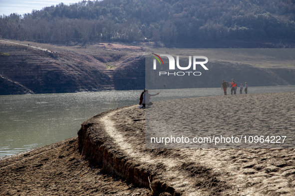 Hundreds of people are visiting the old town of Sant Roma de Sau, where normally the water of the Sau reservoir would almost completely cove...