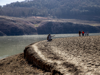 Hundreds of people are visiting the old town of Sant Roma de Sau, where normally the water of the Sau reservoir would almost completely cove...