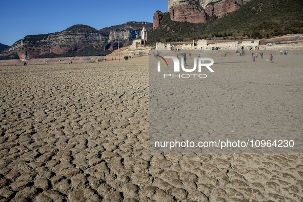 Hundreds of people are visiting the old town of Sant Roma de Sau, where normally the water of the Sau reservoir would almost completely cove...