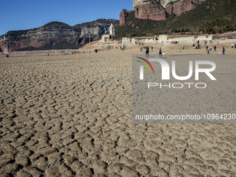 Hundreds of people are visiting the old town of Sant Roma de Sau, where normally the water of the Sau reservoir would almost completely cove...