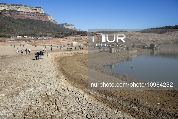 Hundreds of people are visiting the old town of Sant Roma de Sau, where normally the water of the Sau reservoir would almost completely cove...