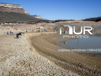 Hundreds of people are visiting the old town of Sant Roma de Sau, where normally the water of the Sau reservoir would almost completely cove...