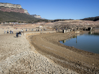 Hundreds of people are visiting the old town of Sant Roma de Sau, where normally the water of the Sau reservoir would almost completely cove...