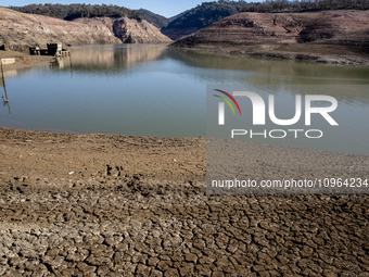 Hundreds of people are visiting the old town of Sant Roma de Sau, where normally the water of the Sau reservoir would almost completely cove...