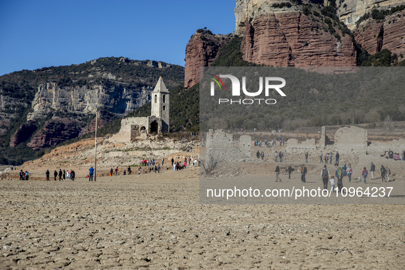 Hundreds of people are visiting the old town of Sant Roma de Sau, where normally the water of the Sau reservoir would almost completely cove...