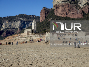 Hundreds of people are visiting the old town of Sant Roma de Sau, where normally the water of the Sau reservoir would almost completely cove...