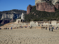 Hundreds of people are visiting the old town of Sant Roma de Sau, where normally the water of the Sau reservoir would almost completely cove...