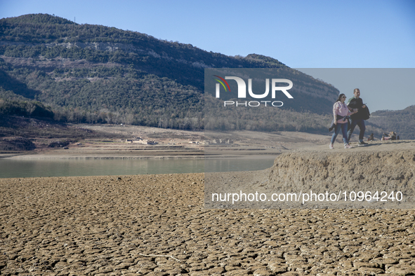 Hundreds of people are visiting the old town of Sant Roma de Sau, where normally the water of the Sau reservoir would almost completely cove...