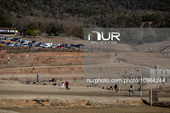 Hundreds of people are visiting the old town of Sant Roma de Sau, where normally the water of the Sau reservoir would almost completely cove...