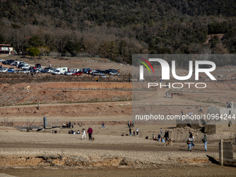 Hundreds of people are visiting the old town of Sant Roma de Sau, where normally the water of the Sau reservoir would almost completely cove...