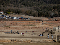 Hundreds of people are visiting the old town of Sant Roma de Sau, where normally the water of the Sau reservoir would almost completely cove...