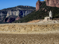 Hundreds of people are visiting the old town of Sant Roma de Sau, where normally the water of the Sau reservoir would almost completely cove...