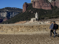 Hundreds of people are visiting the old town of Sant Roma de Sau, where normally the water of the Sau reservoir would almost completely cove...