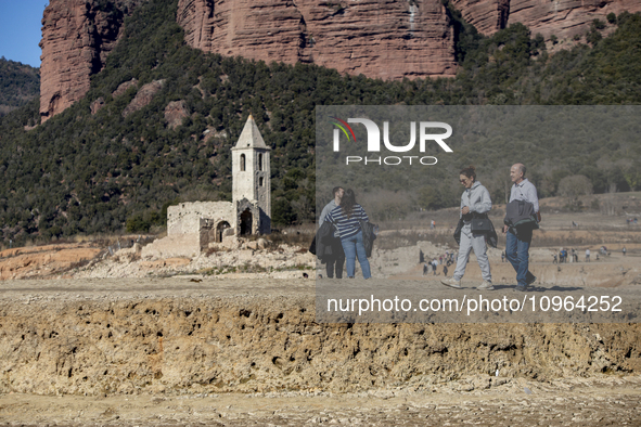 Hundreds of people are visiting the old town of Sant Roma de Sau, where normally the water of the Sau reservoir would almost completely cove...