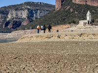 Hundreds of people are visiting the old town of Sant Roma de Sau, where normally the water of the Sau reservoir would almost completely cove...