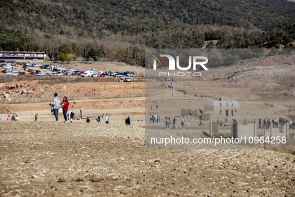 Hundreds of people are visiting the old town of Sant Roma de Sau, where normally the water of the Sau reservoir would almost completely cove...