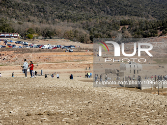 Hundreds of people are visiting the old town of Sant Roma de Sau, where normally the water of the Sau reservoir would almost completely cove...