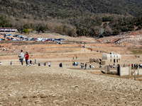 Hundreds of people are visiting the old town of Sant Roma de Sau, where normally the water of the Sau reservoir would almost completely cove...