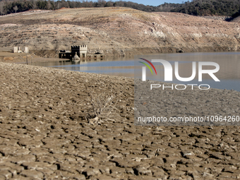 Hundreds of people are visiting the old town of Sant Roma de Sau, where normally the water of the Sau reservoir would almost completely cove...