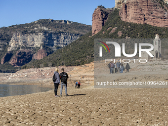 Hundreds of people are visiting the old town of Sant Roma de Sau, where normally the water of the Sau reservoir would almost completely cove...