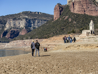 Hundreds of people are visiting the old town of Sant Roma de Sau, where normally the water of the Sau reservoir would almost completely cove...