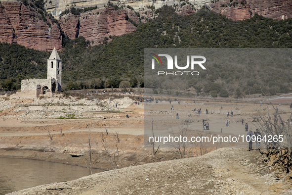 Hundreds of people are visiting the old town of Sant Roma de Sau, where normally the water of the Sau reservoir would almost completely cove...