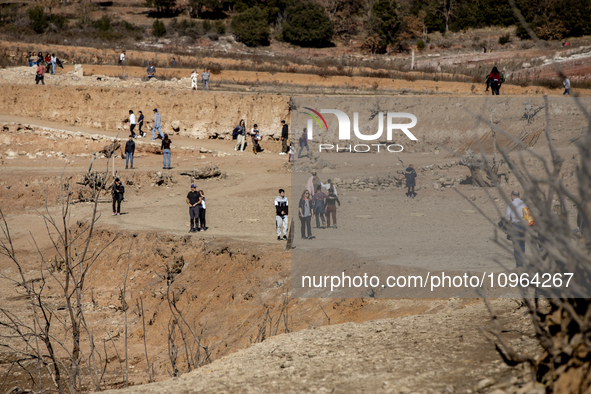 Hundreds of people are visiting the old town of Sant Roma de Sau, where normally the water of the Sau reservoir would almost completely cove...