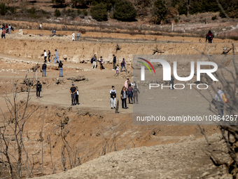 Hundreds of people are visiting the old town of Sant Roma de Sau, where normally the water of the Sau reservoir would almost completely cove...