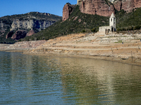 Hundreds of people are visiting the old town of Sant Roma de Sau, where normally the water of the Sau reservoir would almost completely cove...