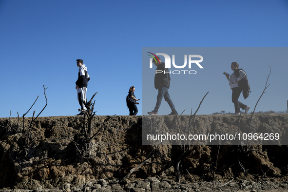 Hundreds of people are visiting the old town of Sant Roma de Sau, where normally the water of the Sau reservoir would almost completely cove...