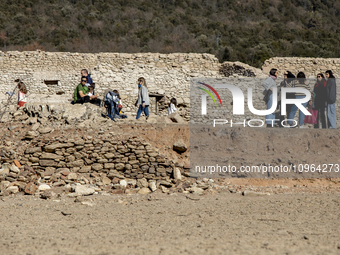 Hundreds of people are visiting the old town of Sant Roma de Sau, where normally the water of the Sau reservoir would almost completely cove...