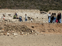 Hundreds of people are visiting the old town of Sant Roma de Sau, where normally the water of the Sau reservoir would almost completely cove...