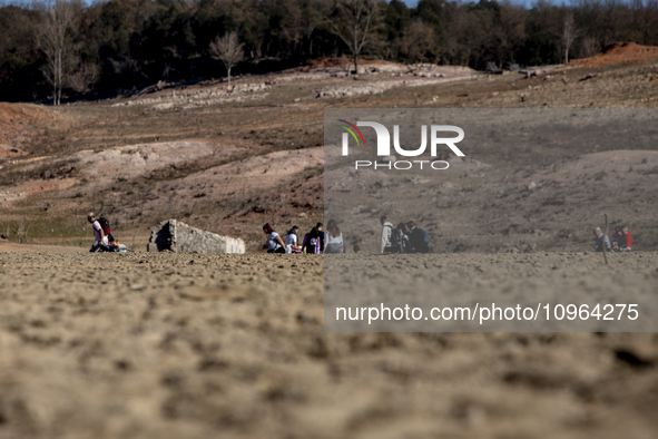 Hundreds of people are visiting the old town of Sant Roma de Sau, where normally the water of the Sau reservoir would almost completely cove...