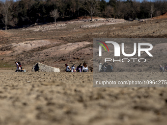 Hundreds of people are visiting the old town of Sant Roma de Sau, where normally the water of the Sau reservoir would almost completely cove...