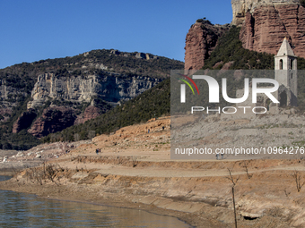 Hundreds of people are visiting the old town of Sant Roma de Sau, where normally the water of the Sau reservoir would almost completely cove...