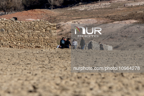 Hundreds of people are visiting the old town of Sant Roma de Sau, where normally the water of the Sau reservoir would almost completely cove...