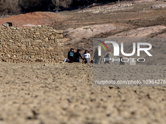 Hundreds of people are visiting the old town of Sant Roma de Sau, where normally the water of the Sau reservoir would almost completely cove...