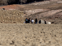 Hundreds of people are visiting the old town of Sant Roma de Sau, where normally the water of the Sau reservoir would almost completely cove...