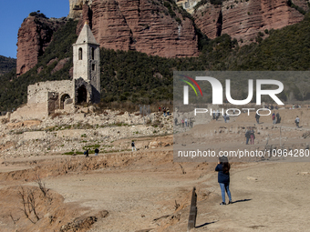 Hundreds of people are visiting the old town of Sant Roma de Sau, where normally the water of the Sau reservoir would almost completely cove...