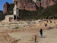 Hundreds of people are visiting the old town of Sant Roma de Sau, where normally the water of the Sau reservoir would almost completely cove...